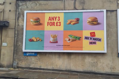 Billboard advertising a range of unhealthy products. Credit: Fran Bernhardt