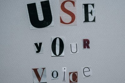 Use Your Voice inscription on gray background. Copyright: Polina Kovaleva | Pexels