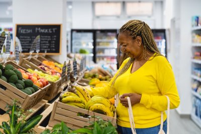 A woman shops for fruit in a shop. Credit: AlessandroBiasciolli: Shutterstock