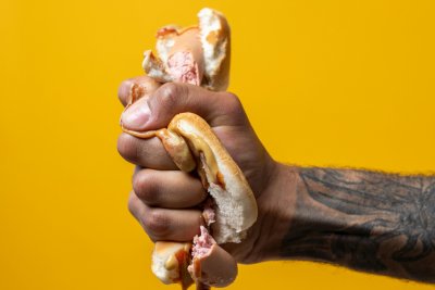 A hand squeezing a hotdog. Copyright: cottonbro studio | pexels